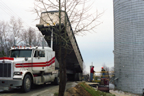 Photo of a dump truck dumping sand