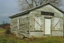 Wooden building with a Hewlett station sign on it